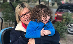 Donna Rosa sits in a golf cart with her young grandchild in her lap